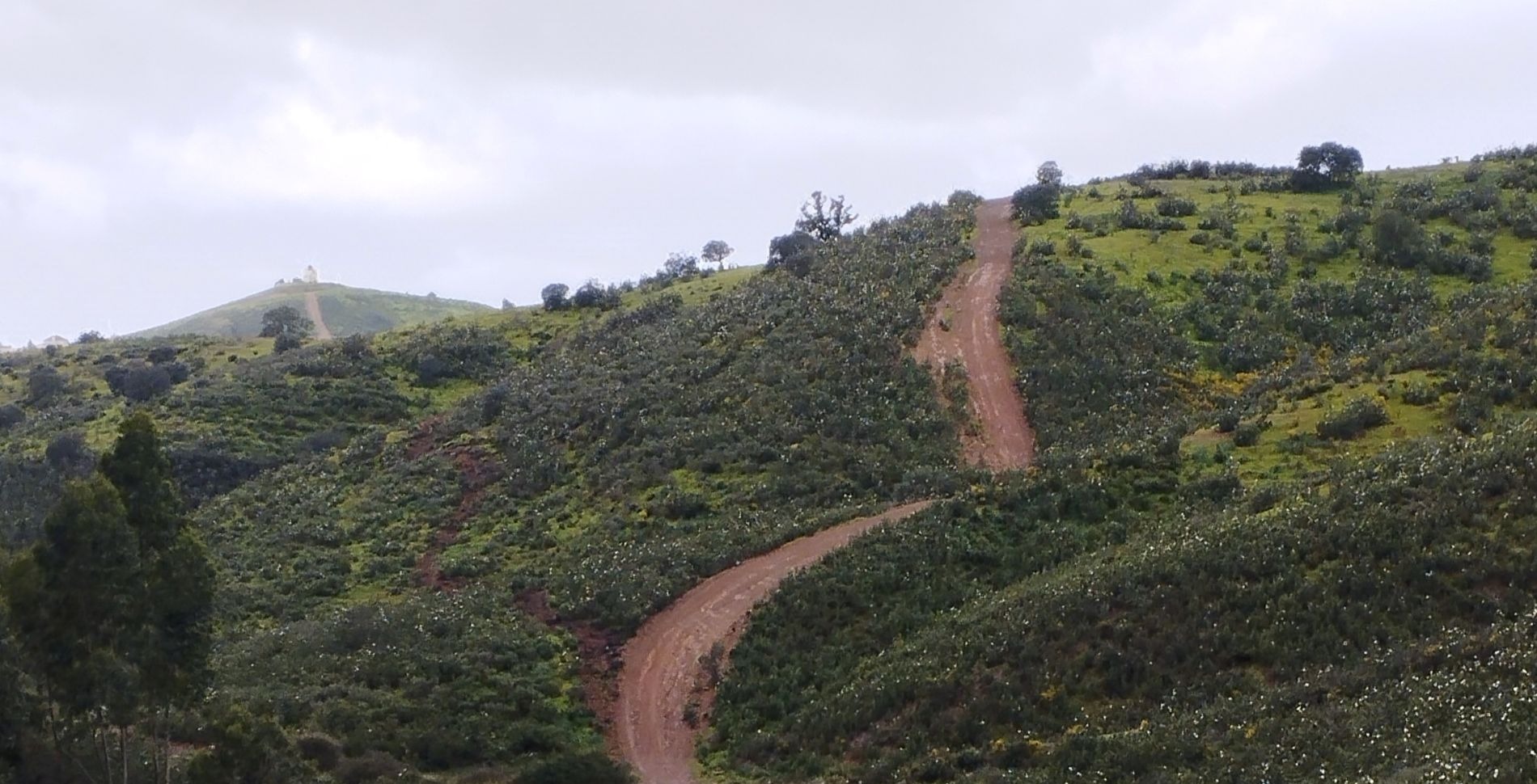 A winding dirt road in Portugal during a self-supported hike